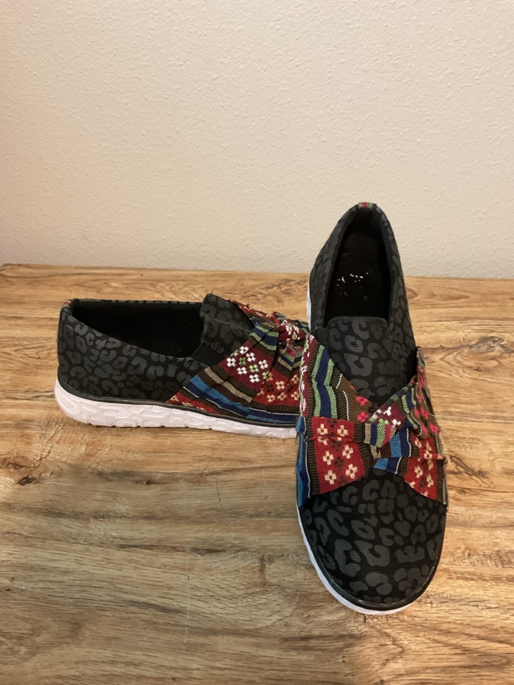 Muk Luks Black Patterned Slip-On Sneakers with Multicolor Bow